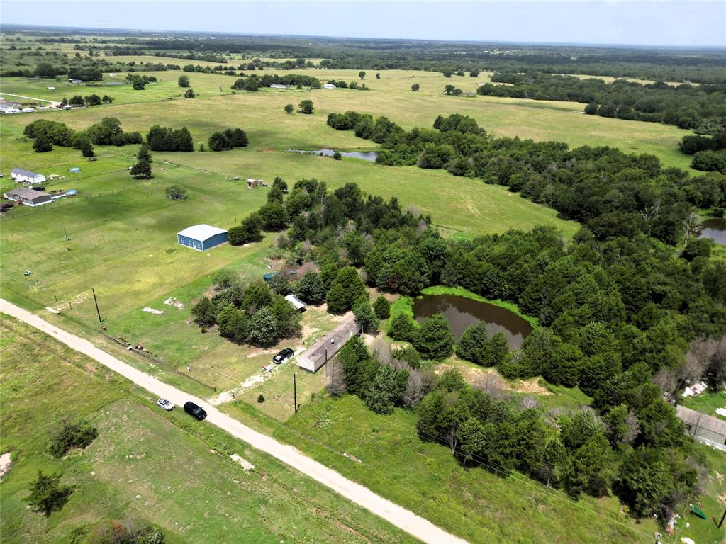 2087 Meadow Road Kerens, TX 75144 - Photo 26 of 28 a view of a lush green field with lots of buildings in the background