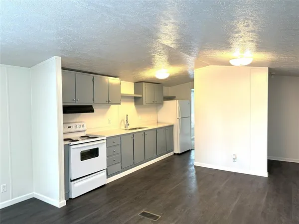 a kitchen with stainless steel appliances a stove a microwave and a refrigerator