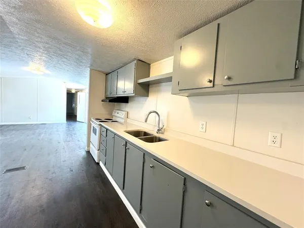 a kitchen with stainless steel appliances granite countertop a sink and cabinets