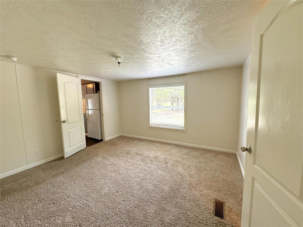 2087 Meadow Road Kerens, TX 75144 - Photo 10 of 28 an empty room with windows