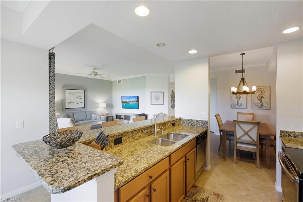9844 Venezia Circle, Unit 714 Naples, FL 34113 - Photo 15 of 50 a living room with granite countertop furniture and fireplace
