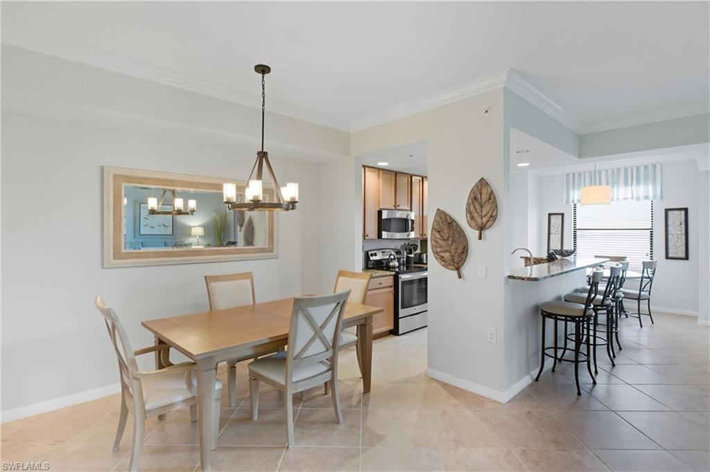 9844 Venezia Circle, Unit 714 Naples, FL 34113 - Photo 19 of 50 a dining room with furniture and window