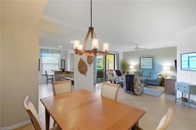 a living room with furniture a chandelier and a table