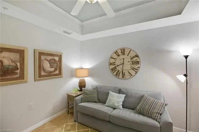 a living room with furniture and a wall painting