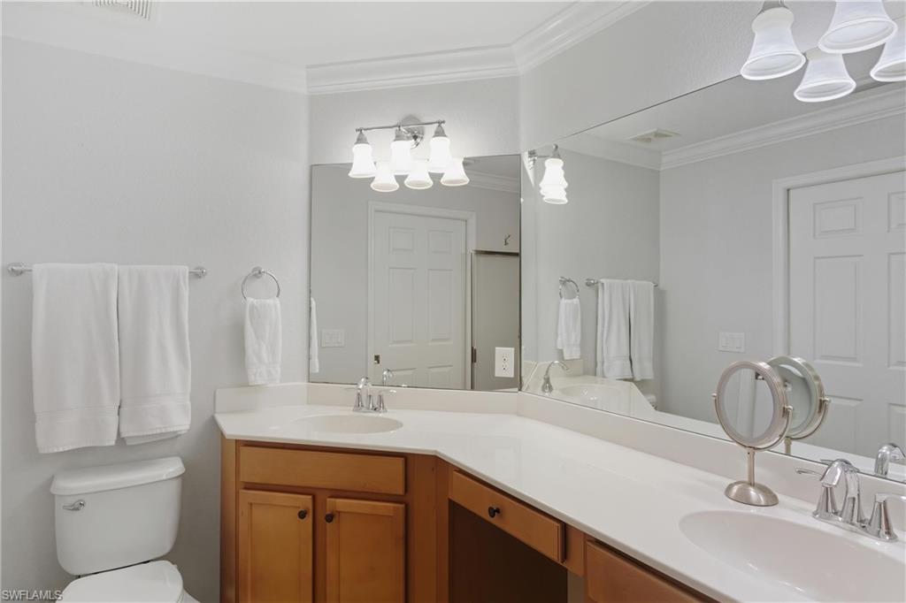 9844 Venezia Circle, Unit 714 Naples, FL 34113 - Photo 28 of 50 a bathroom with a sink and a mirror