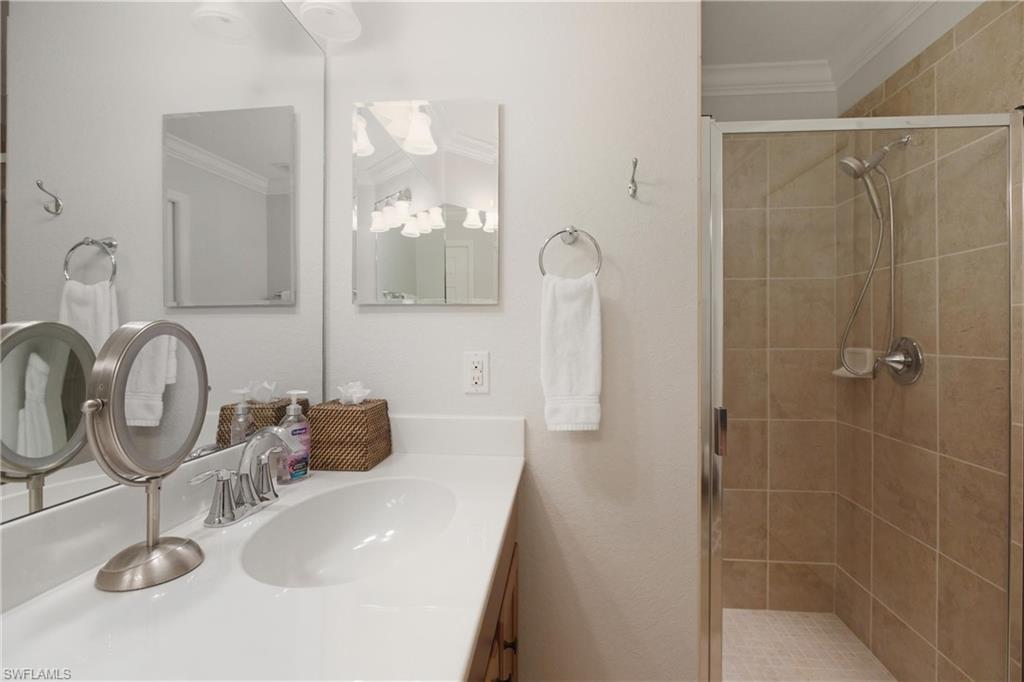 9844 Venezia Circle, Unit 714 Naples, FL 34113 - Photo 29 of 50 a bathroom with a sink and a mirror