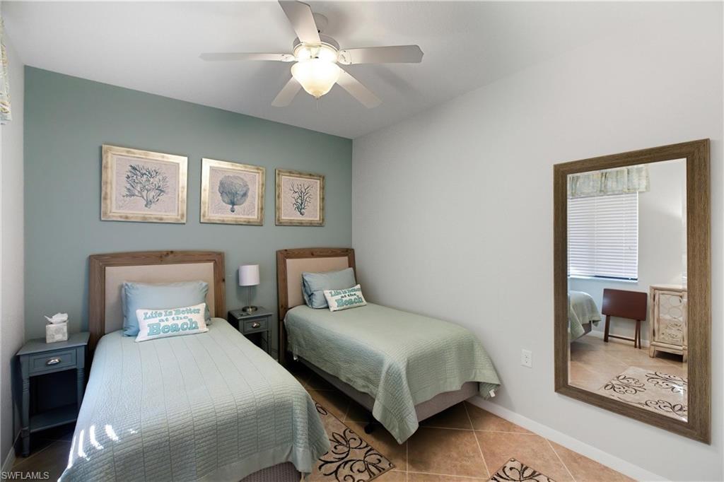 9844 Venezia Circle, Unit 714 Naples, FL 34113 - Photo 31 of 50 a bedroom with a bed and a painting on the wall