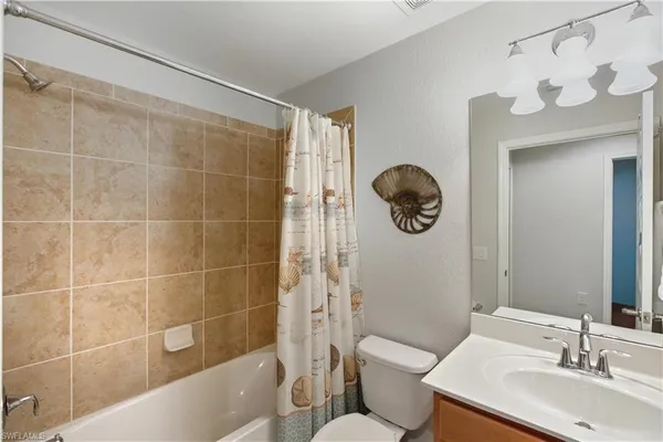 a bathroom with a toilet a sink and bathtub