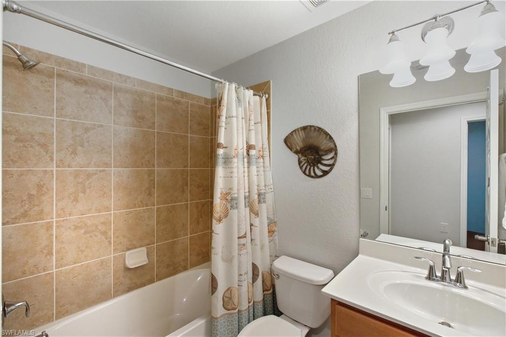 9844 Venezia Circle, Unit 714 Naples, FL 34113 - Photo 34 of 50 a bathroom with a toilet a sink and bathtub