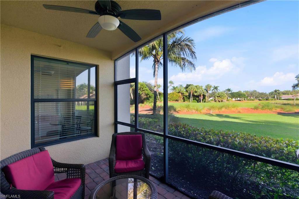 9844 Venezia Circle, Unit 714 Naples, FL 34113 - Photo 37 of 50 a view of a porch with furniture and a yard