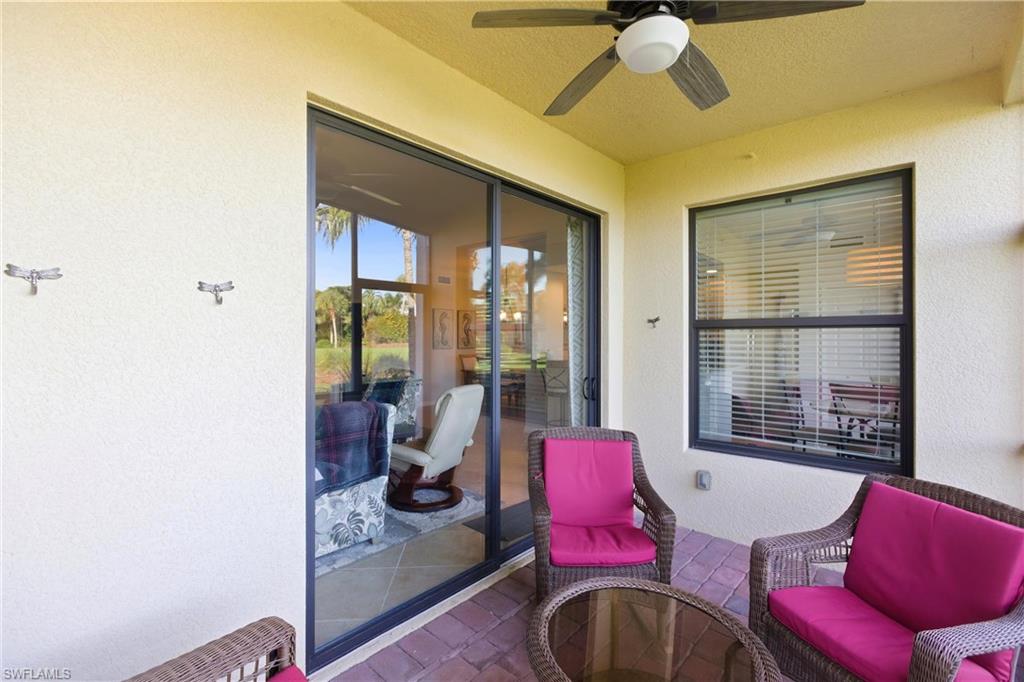 9844 Venezia Circle, Unit 714 Naples, FL 34113 - Photo 38 of 50 a living room with furniture and a large window