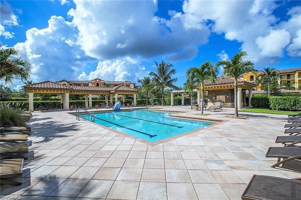 9844 Venezia Circle, Unit 714 Naples, FL 34113 - Photo 49 of 50 a view of a white building with a swimming pool