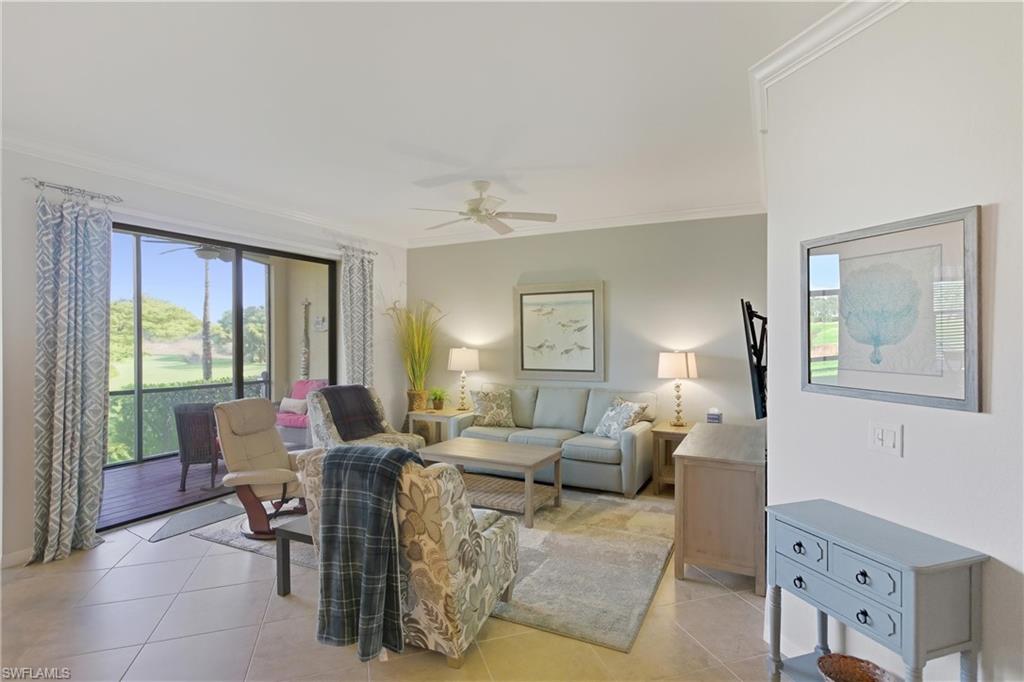 9844 Venezia Circle, Unit 714 Naples, FL 34113 - Photo 9 of 50 a living room with furniture and large windows
