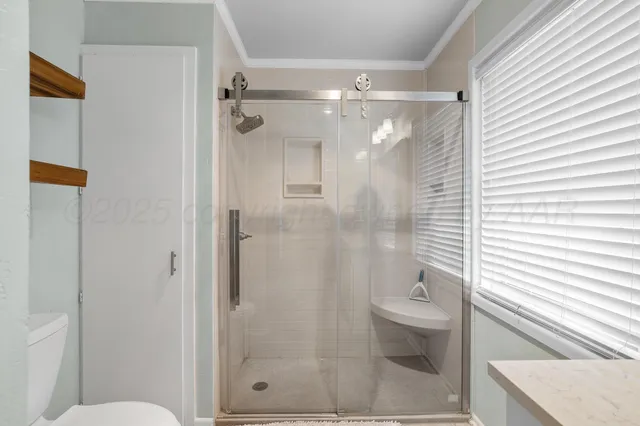 a bathroom with a glass shower door