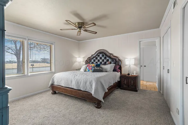 a spacious bedroom with a bed and a window