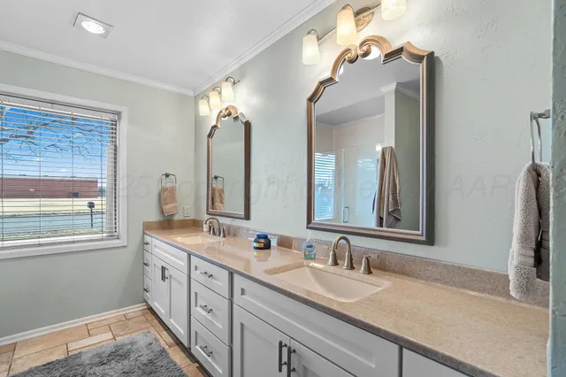 a bathroom with a double vanity sink and a mirror
