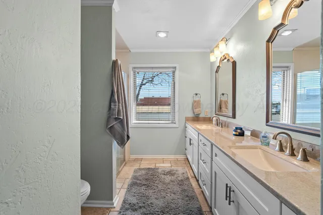 a bathroom with a double vanity sink and a mirror
