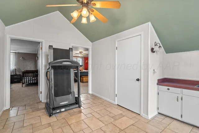 a view of a hallway with entryway and chandelier