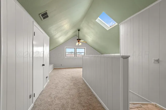 a view of a hallway with windows