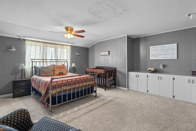 a bedroom with bed and a chandelier