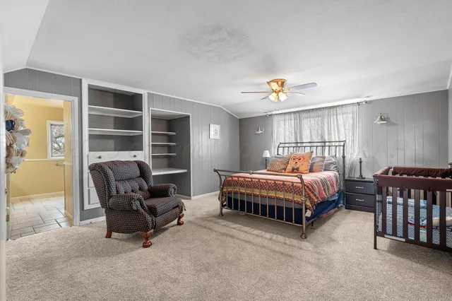 a bedroom with furniture and a window