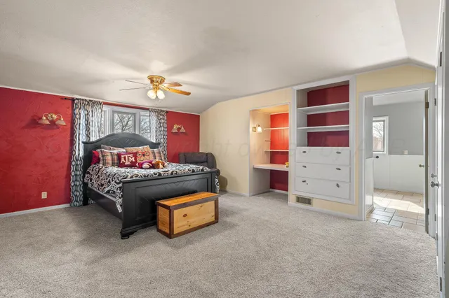a spacious bathroom with a granite countertop sink a mirror and a window