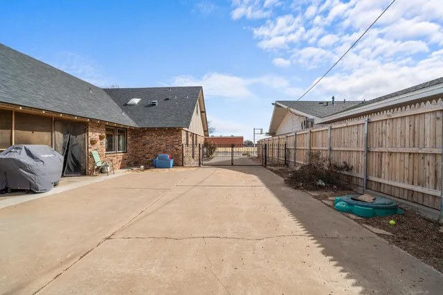 a view of a house with a wooden fence