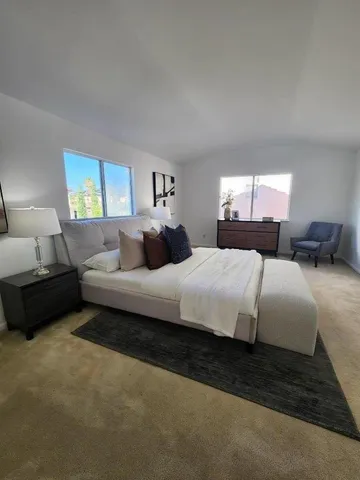 a bedroom with a bed and a window