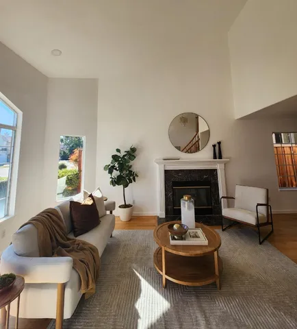 a living room with furniture and a fireplace