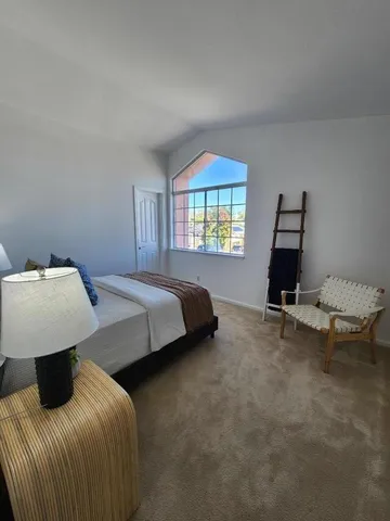 a bedroom with a bed and window