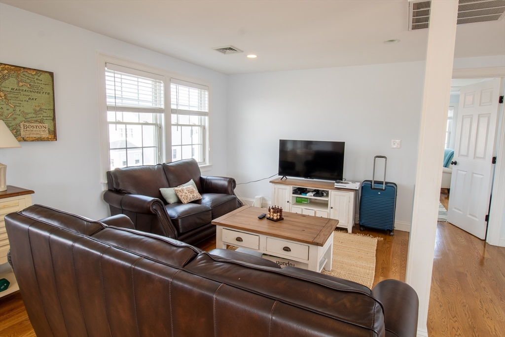 117 River Street Scituate, MA 02050 - Photo 17 of 23 a living room with furniture and a flat screen tv