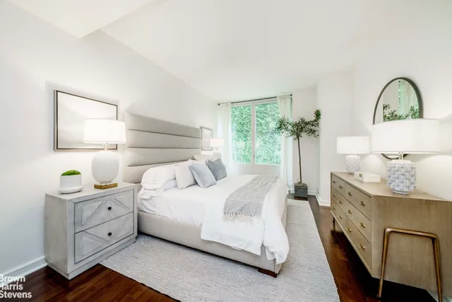 a living room with furniture a table and a large mirror