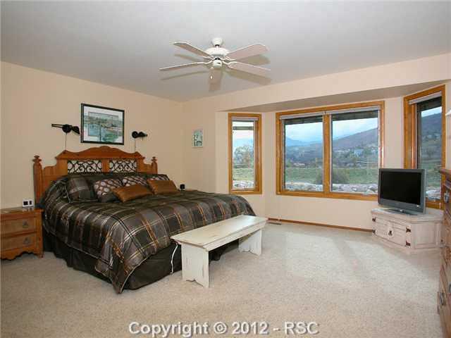 5530 Wilson Road Colorado Springs, CO 80919 - Photo 12 of 20 Main level masterbedroom with Mountain view through Bay window