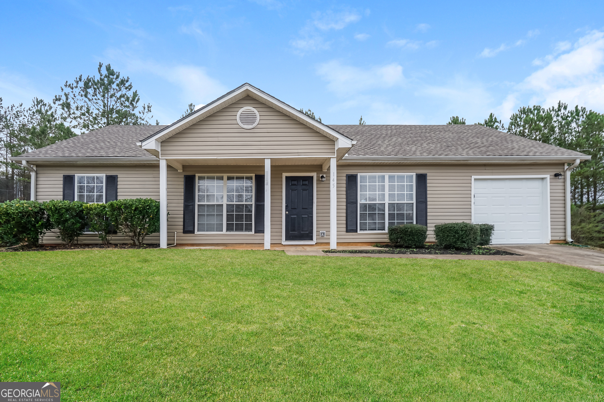 a front view of a house with a yard and porch