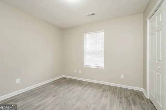 wooden floor in an empty room with a window