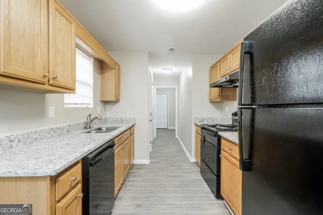 a kitchen with a stove and a sink