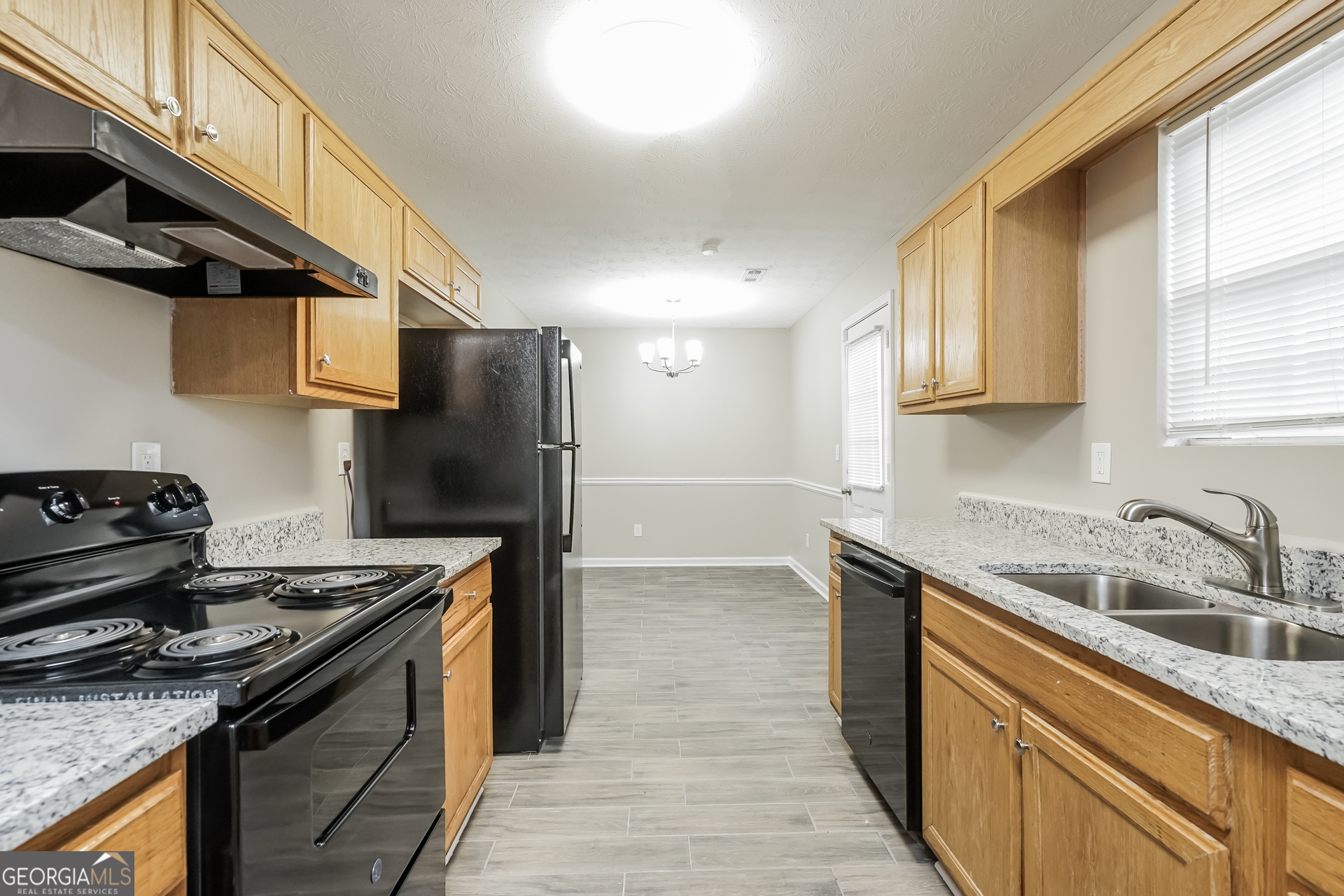 145 Fairclift Drive Covington, GA 30016 - Photo 7 of 16 a kitchen with a stove and a sink