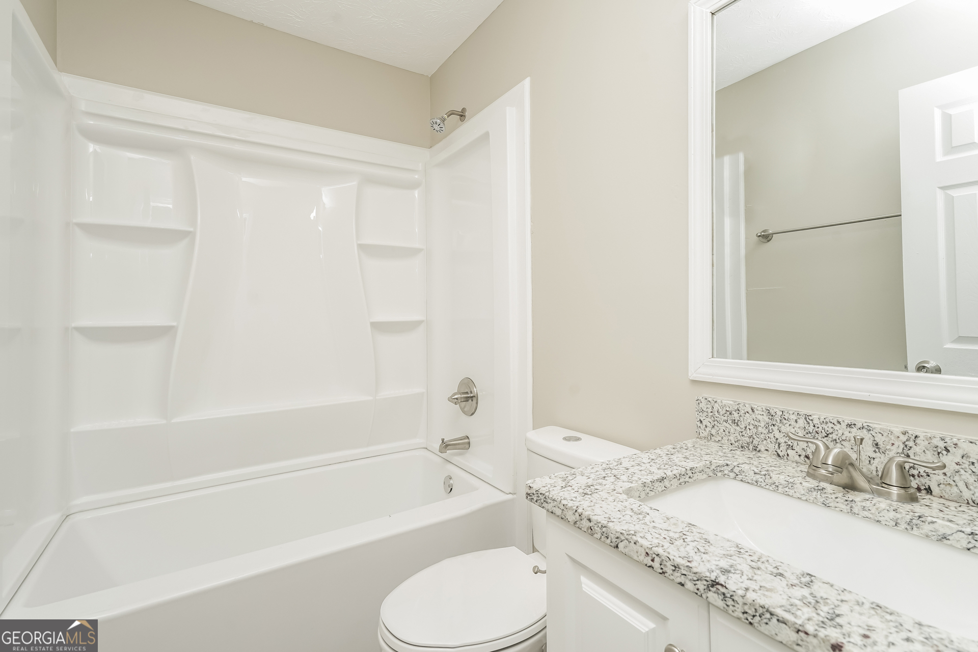 145 Fairclift Drive Covington, GA 30016 - Photo 10 of 16 a bathroom with a granite countertop sink toilet and shower
