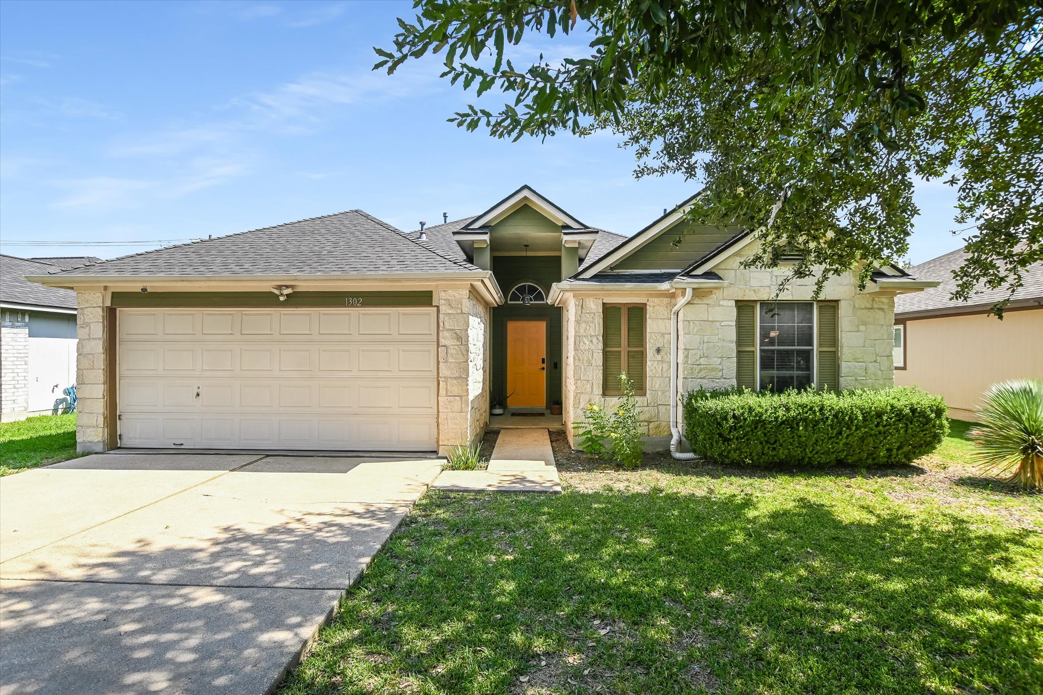 1302 Redbud Lane Leander, TX 78641 - Photo 25 of 28 a front view of a house with a yard and garage