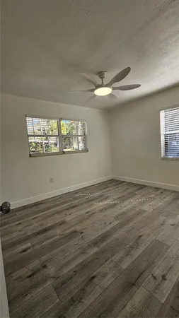 a view of a room with wooden floor and window