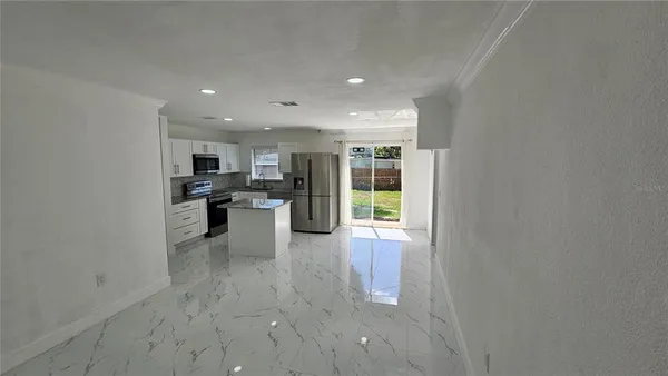 a kitchen with a refrigerator and a sink