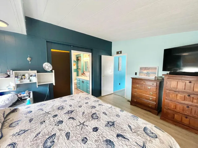 a bedroom with a bed and a flat screen tv