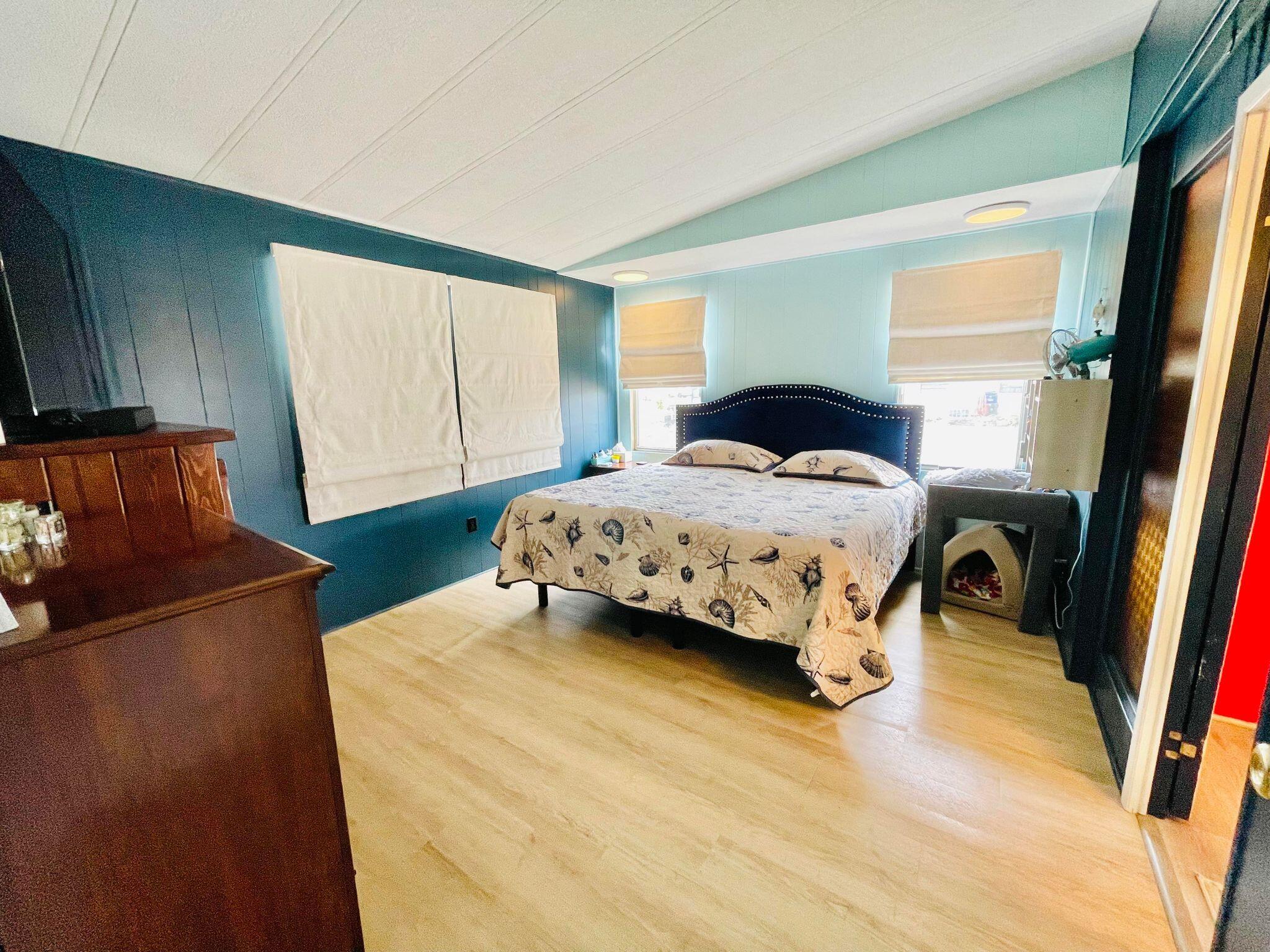 2301 Southeast 33rd Street Okeechobee, FL 34974 - Photo 13 of 31 a bedroom with a bed and wooden floor