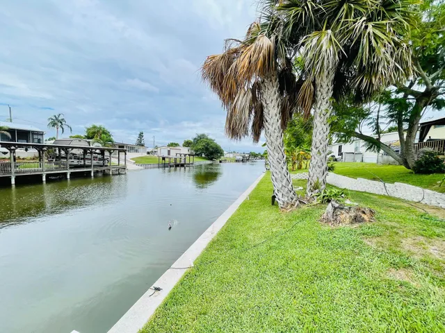 a view of a lake with houses in the back