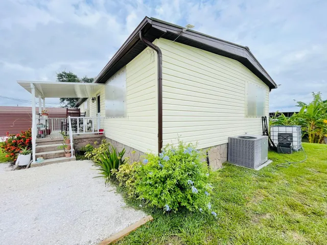 a view of a house with backyard and sitting area