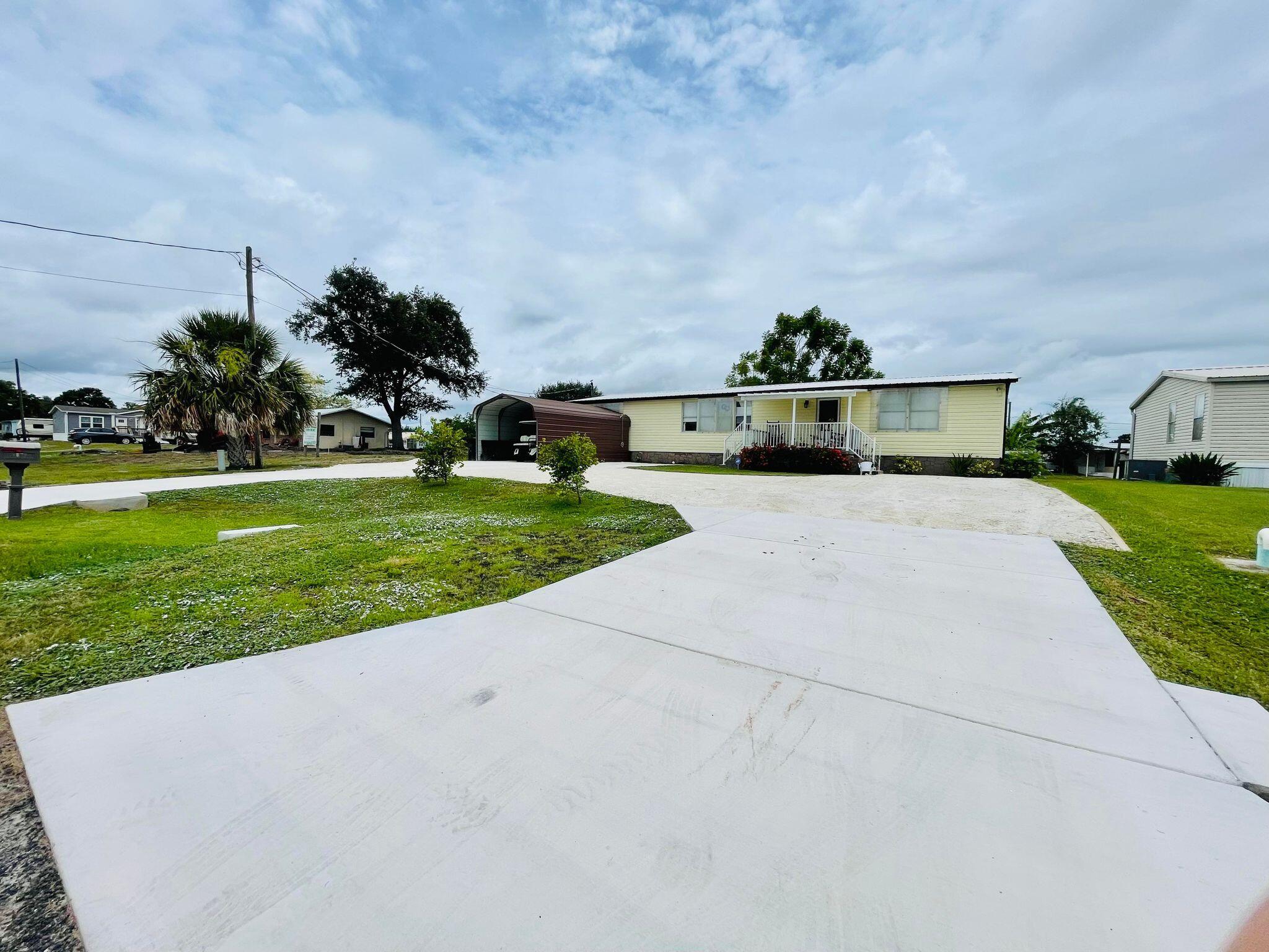 2301 Southeast 33rd Street Okeechobee, FL 34974 - Photo 4 of 31 a view of a terrace with yard and mountain view in back