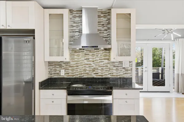 a kitchen with granite countertop a stove and a cabinets