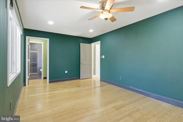a bathroom with a granite countertop sink a mirror and a toilet