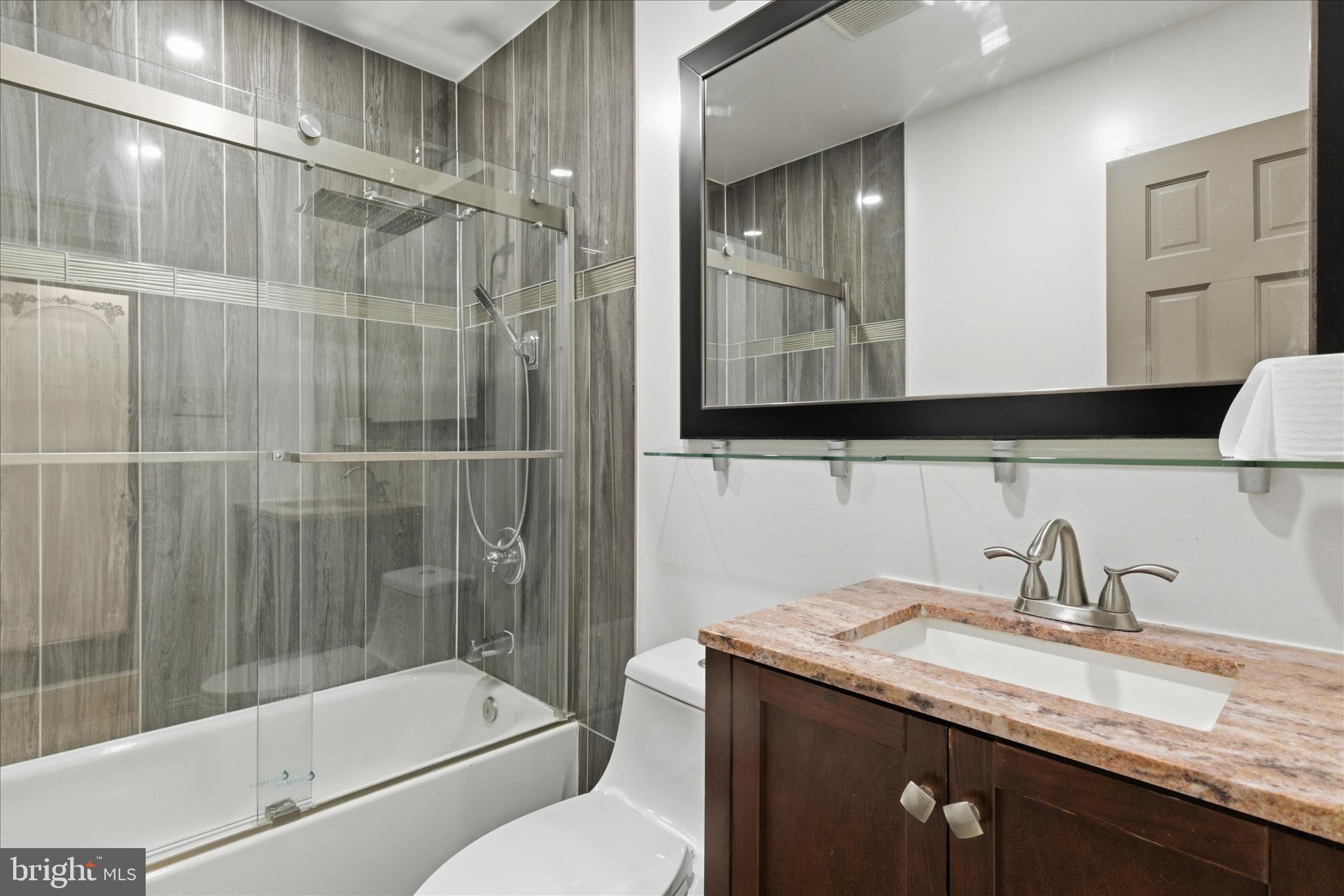 5515 Westcliff Court Burke, VA 22015 - Photo 26 of 47 a bathroom with a granite countertop sink a toilet and shower