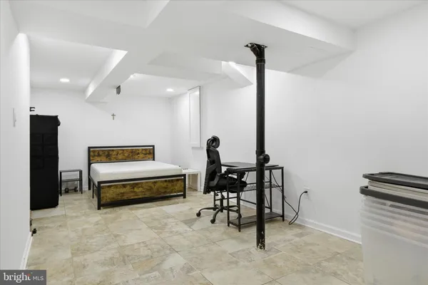 a kitchen with kitchen island a dining table chairs and white cabinets